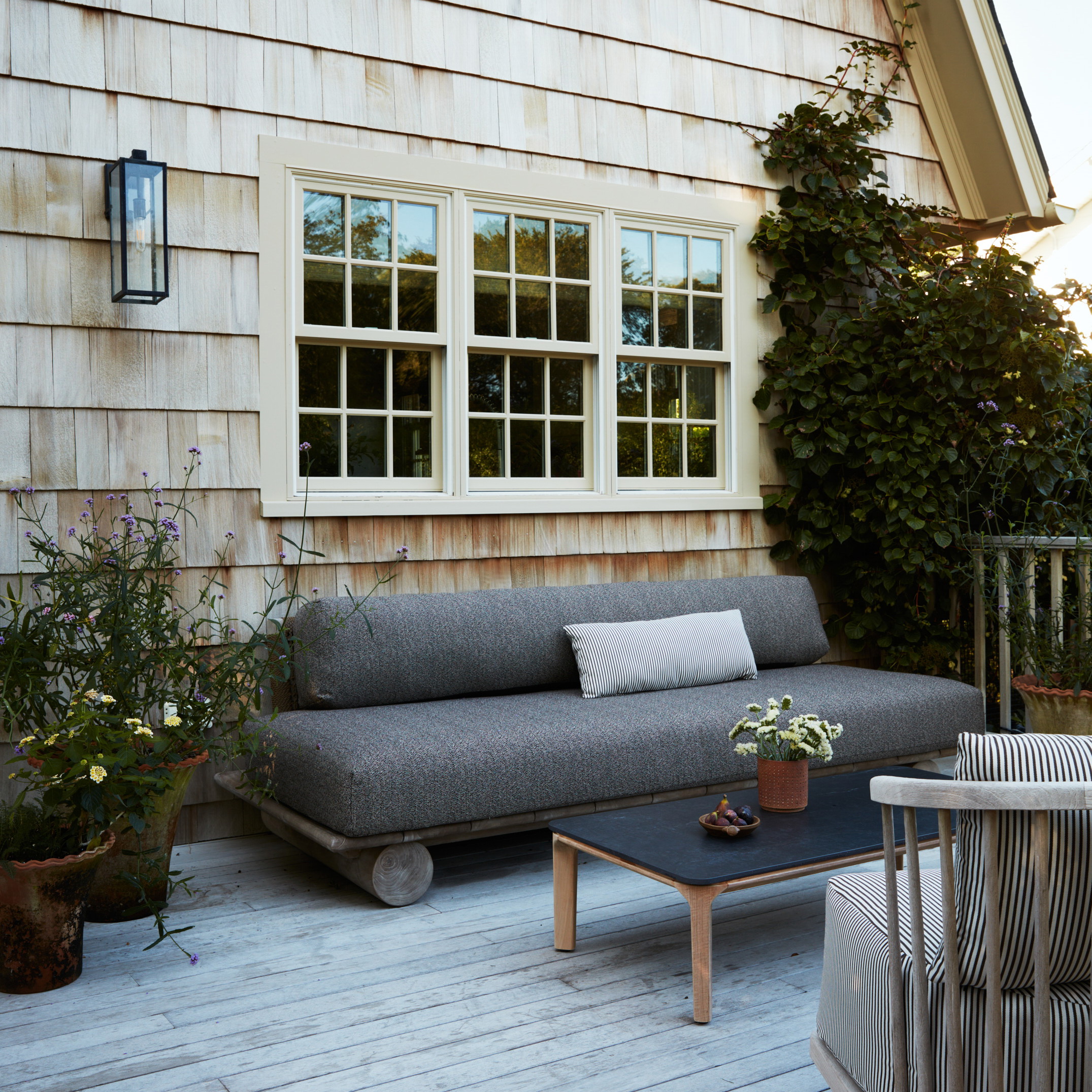 a couch sitting on top of a wooden deck