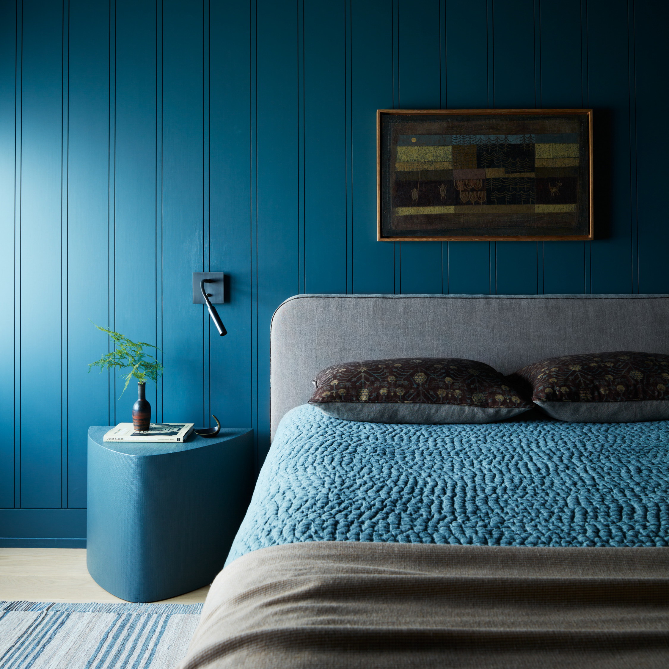 a bedroom with blue walls and a large bed