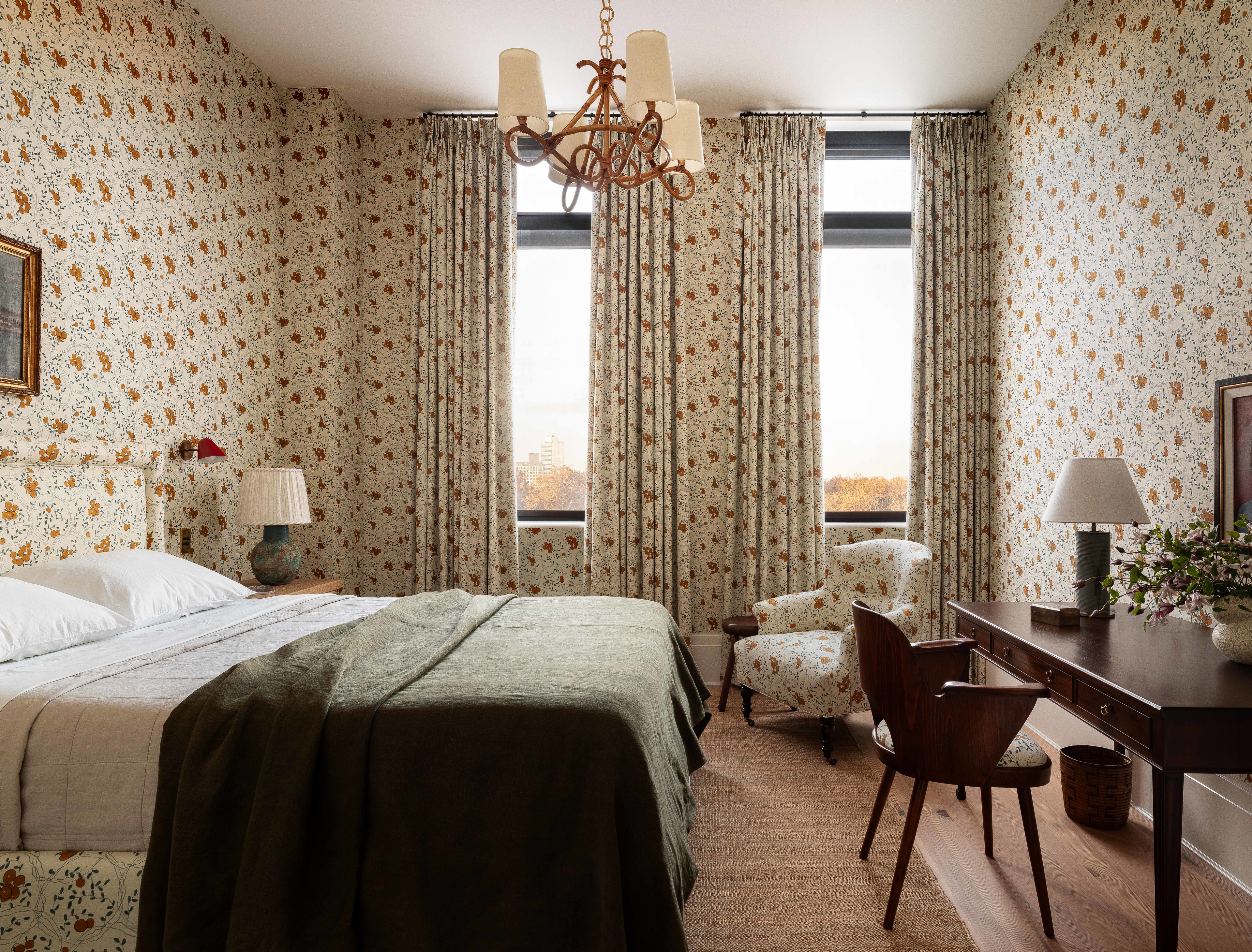 a bedroom with a large bed and a chandelier
