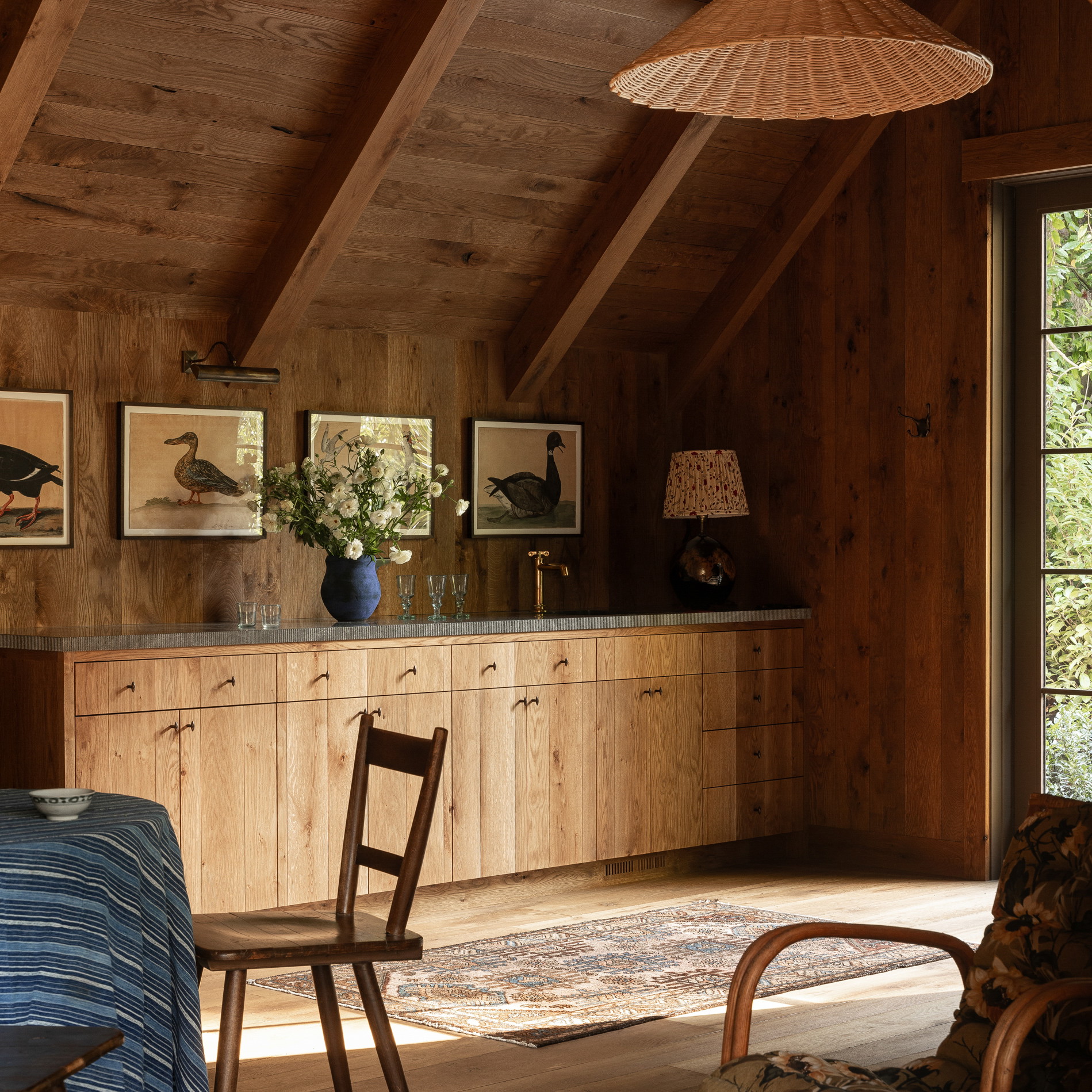 a room with a table, chairs, and pictures on the wall