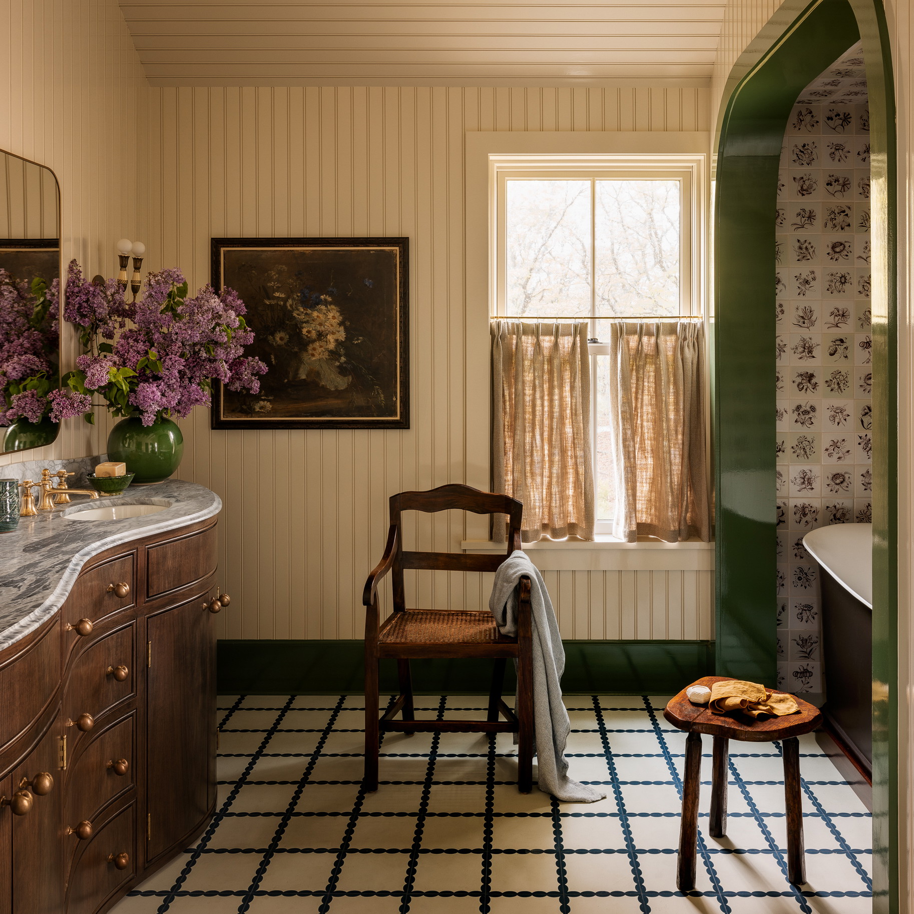a bathroom with a sink, a chair and a window