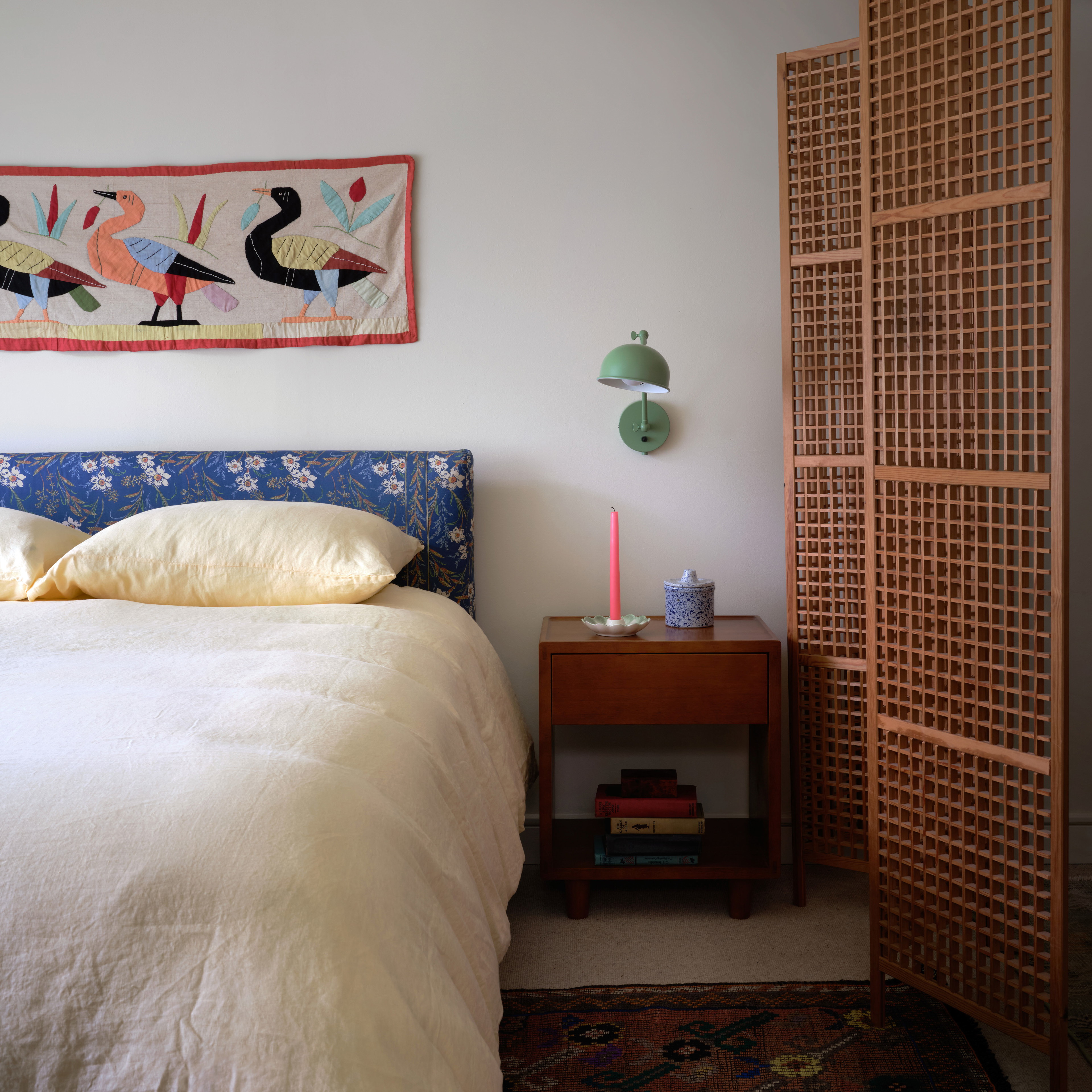 a bedroom with a bed and a painting on the wall