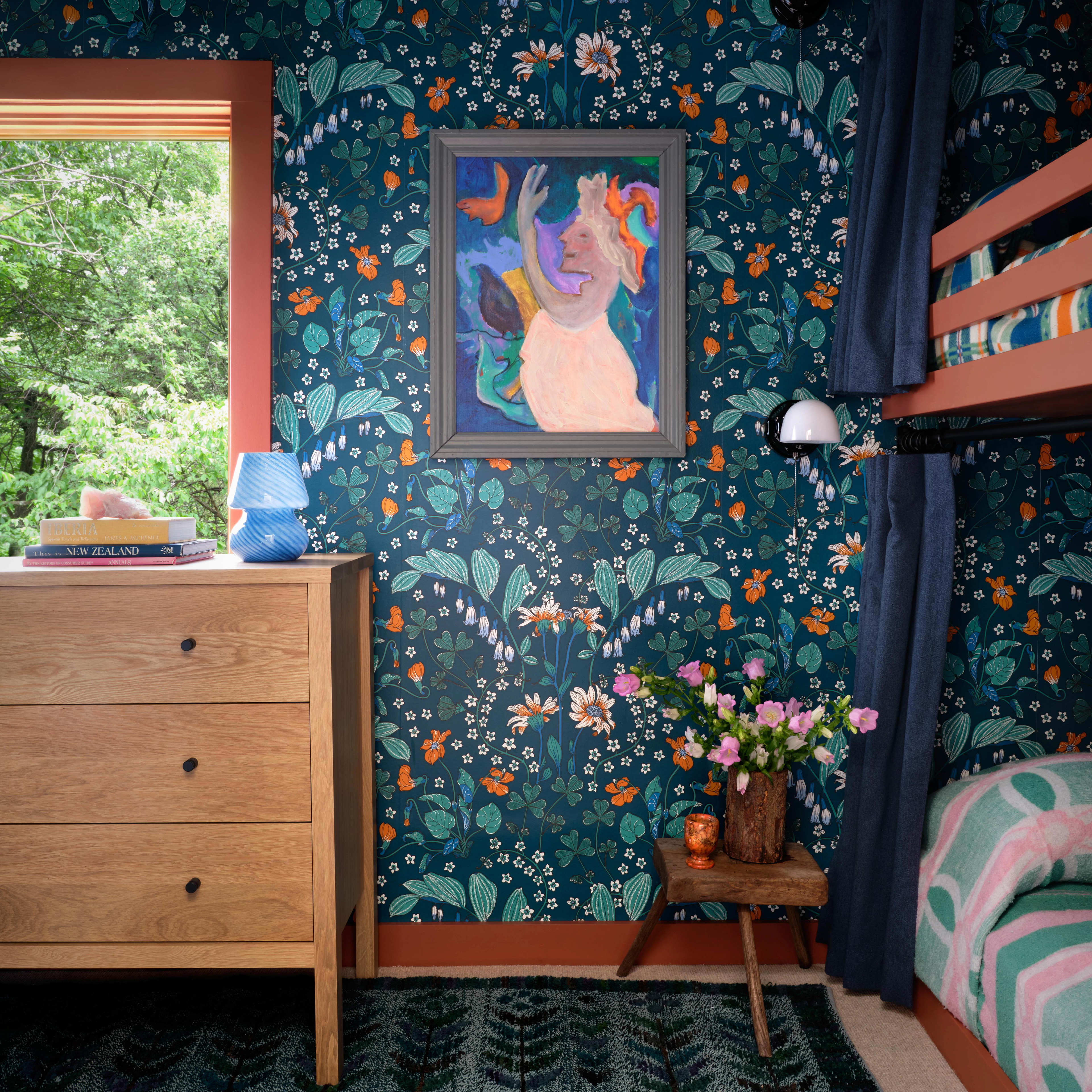 a bedroom with a dresser and a painting on the wall