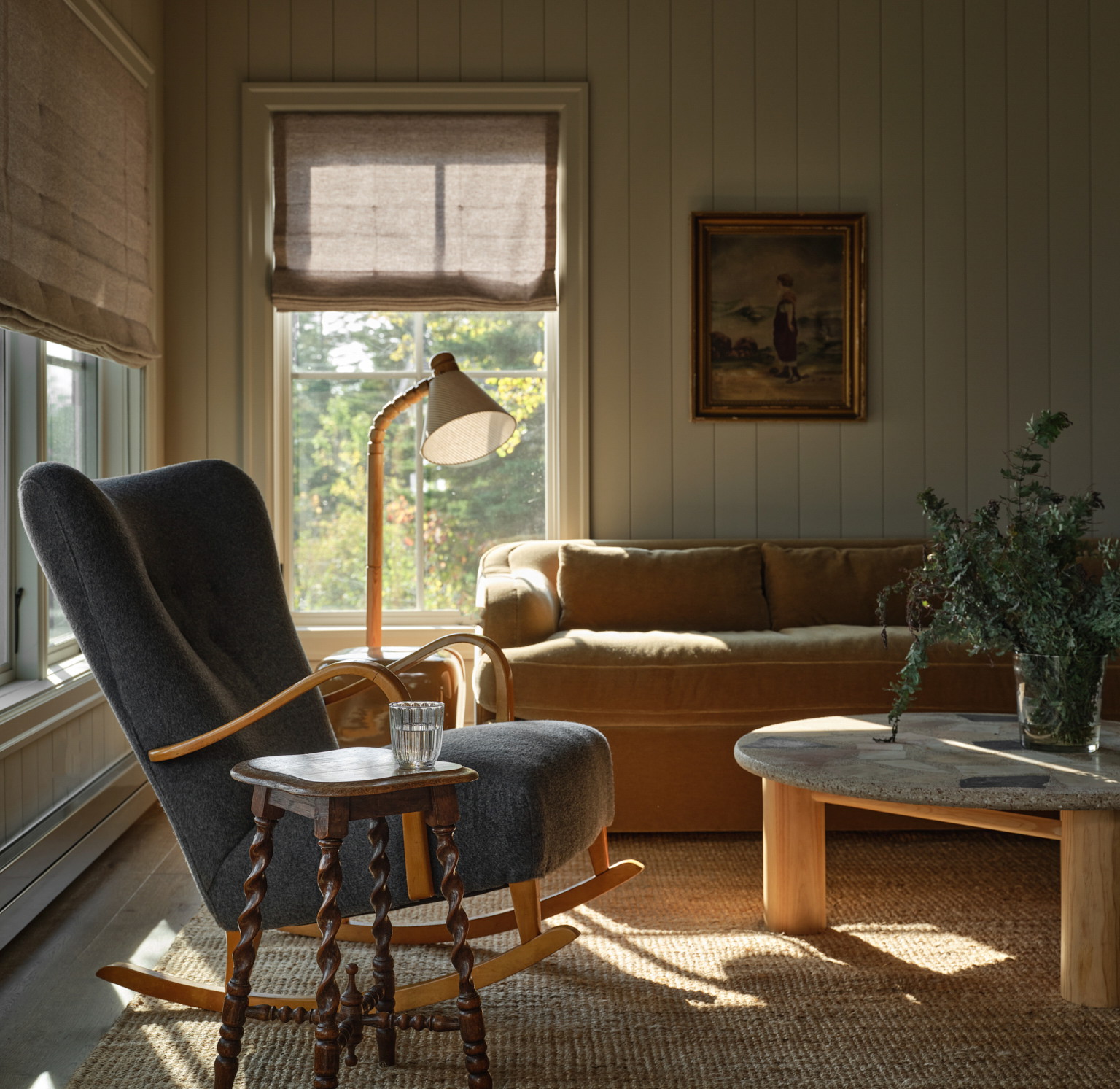 a living room filled with furniture and a lamp