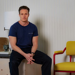 a man sitting on a chair in a room