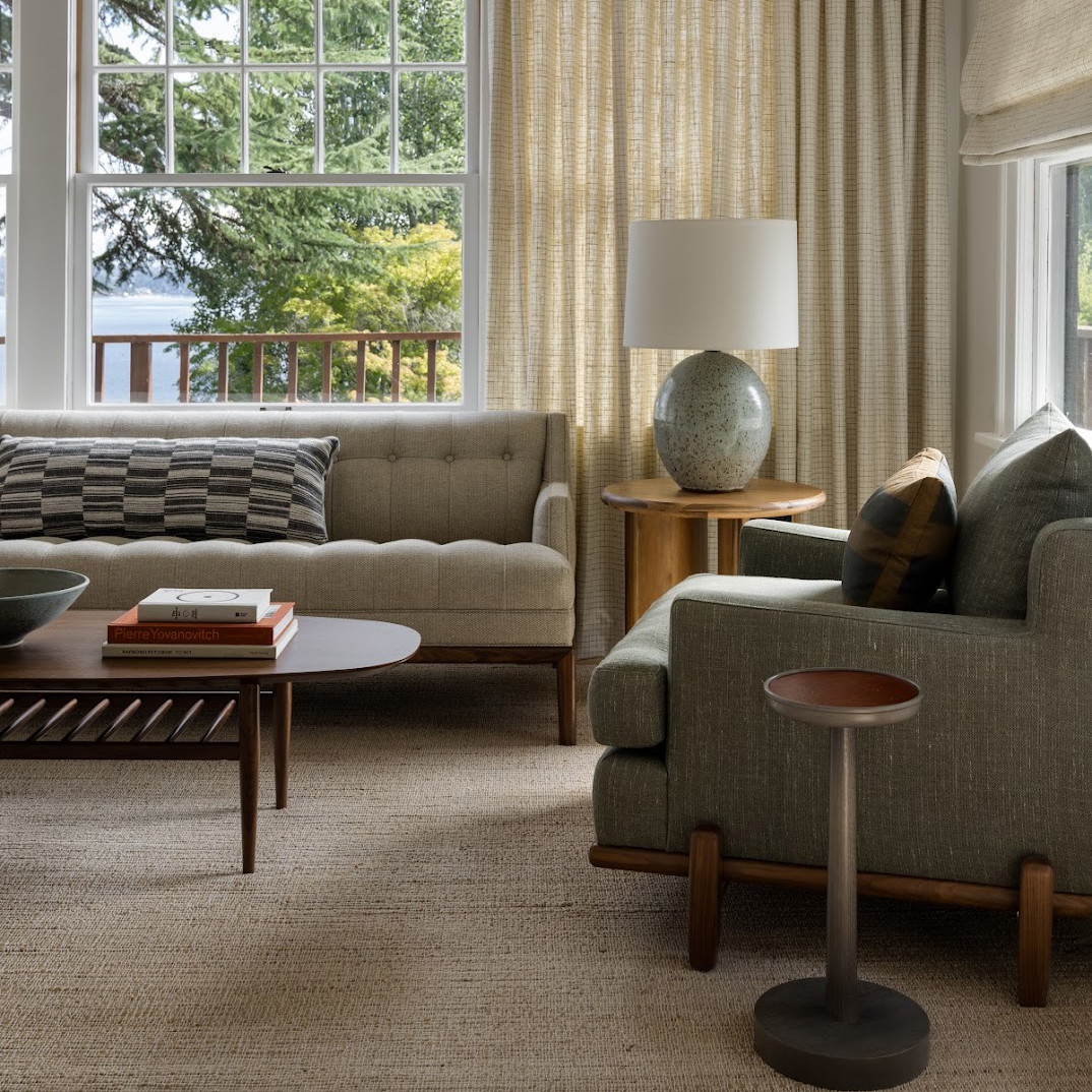 a living room filled with furniture and a large window