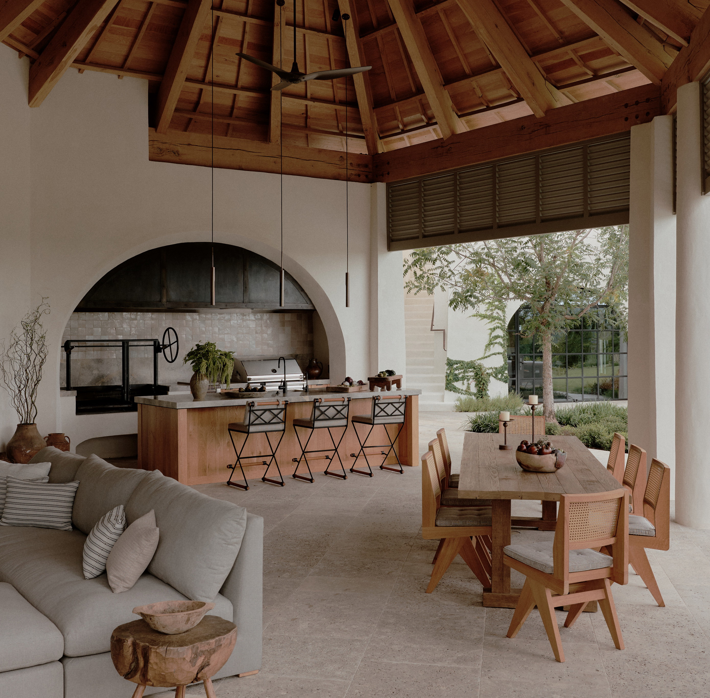 a living room filled with furniture and a wooden ceiling