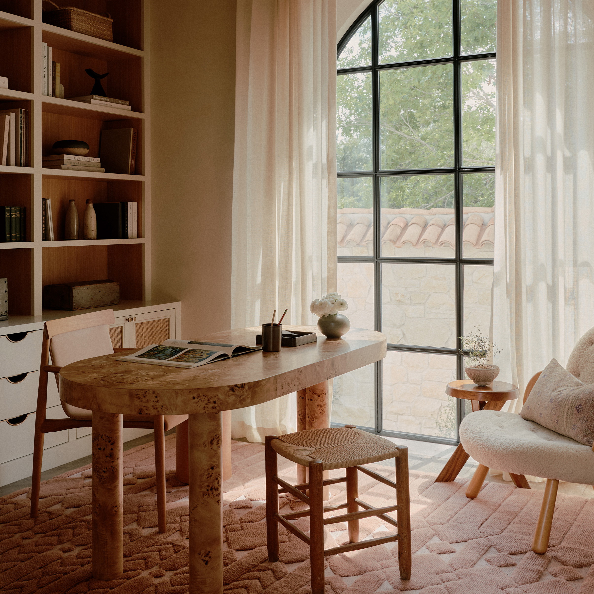 a living room with a table and chairs