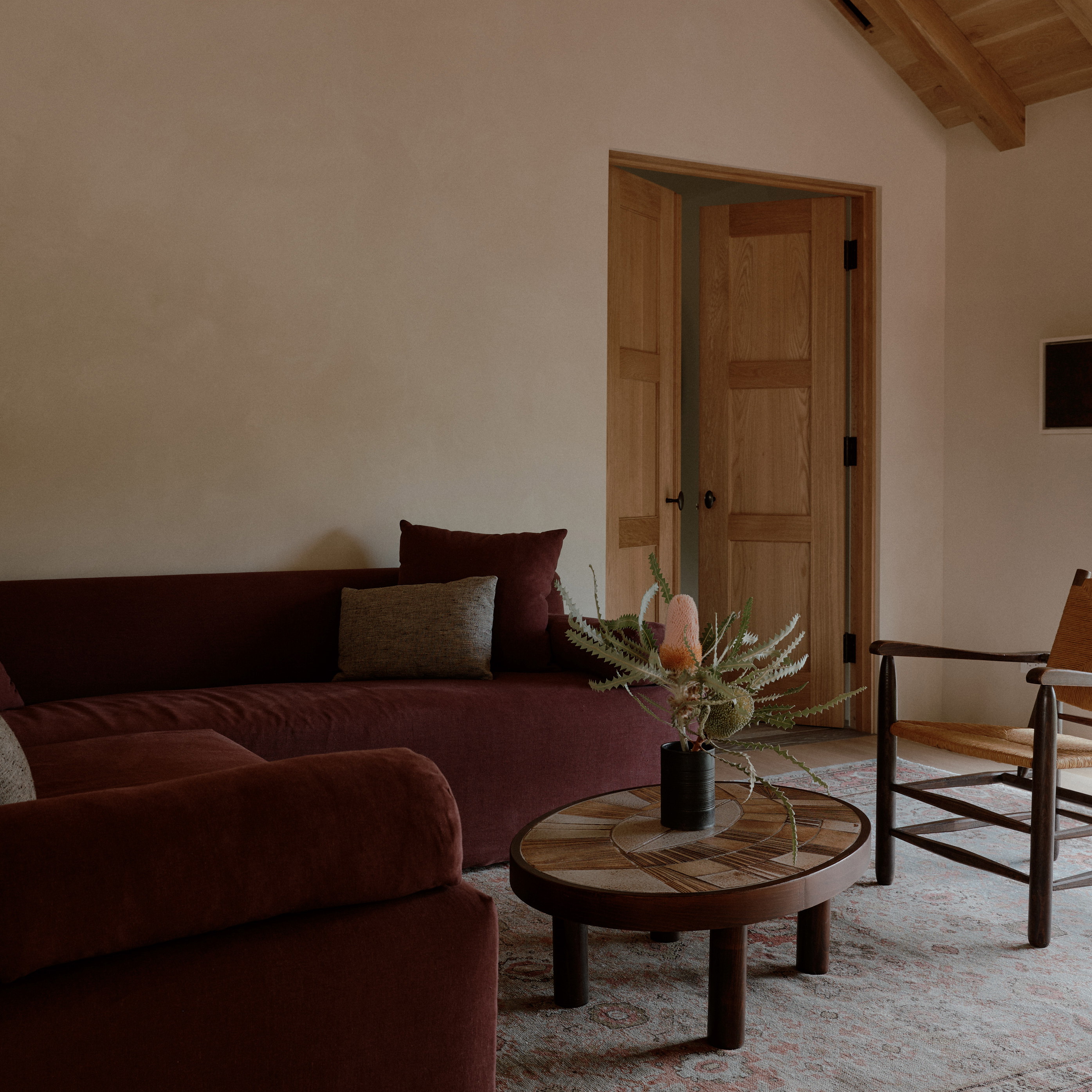 a living room filled with furniture and a wooden table