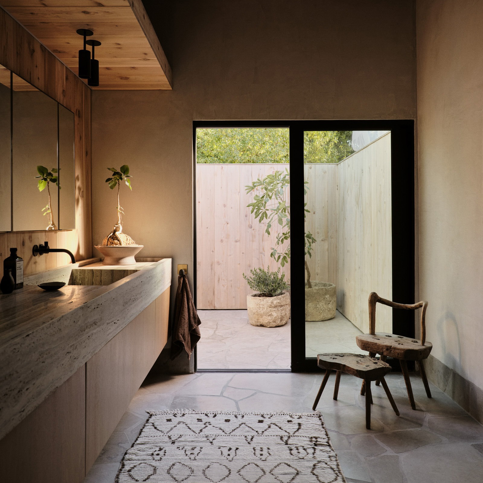 a bathroom with a sink and a chair in it