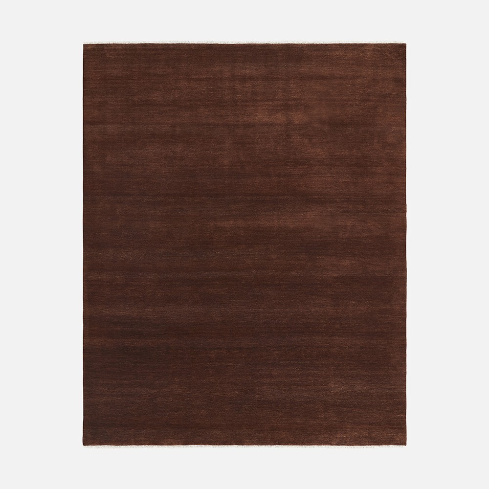 a brown rug with a white border