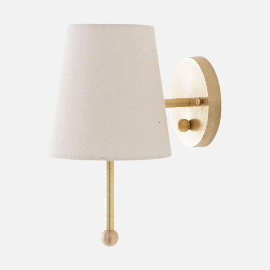 a wall light with a white shade on it