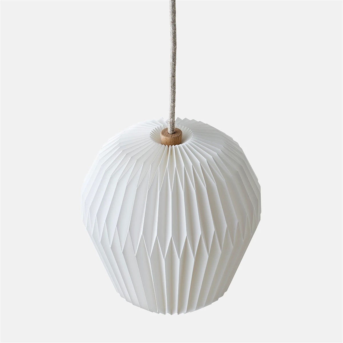 a white paper lantern hanging from a string