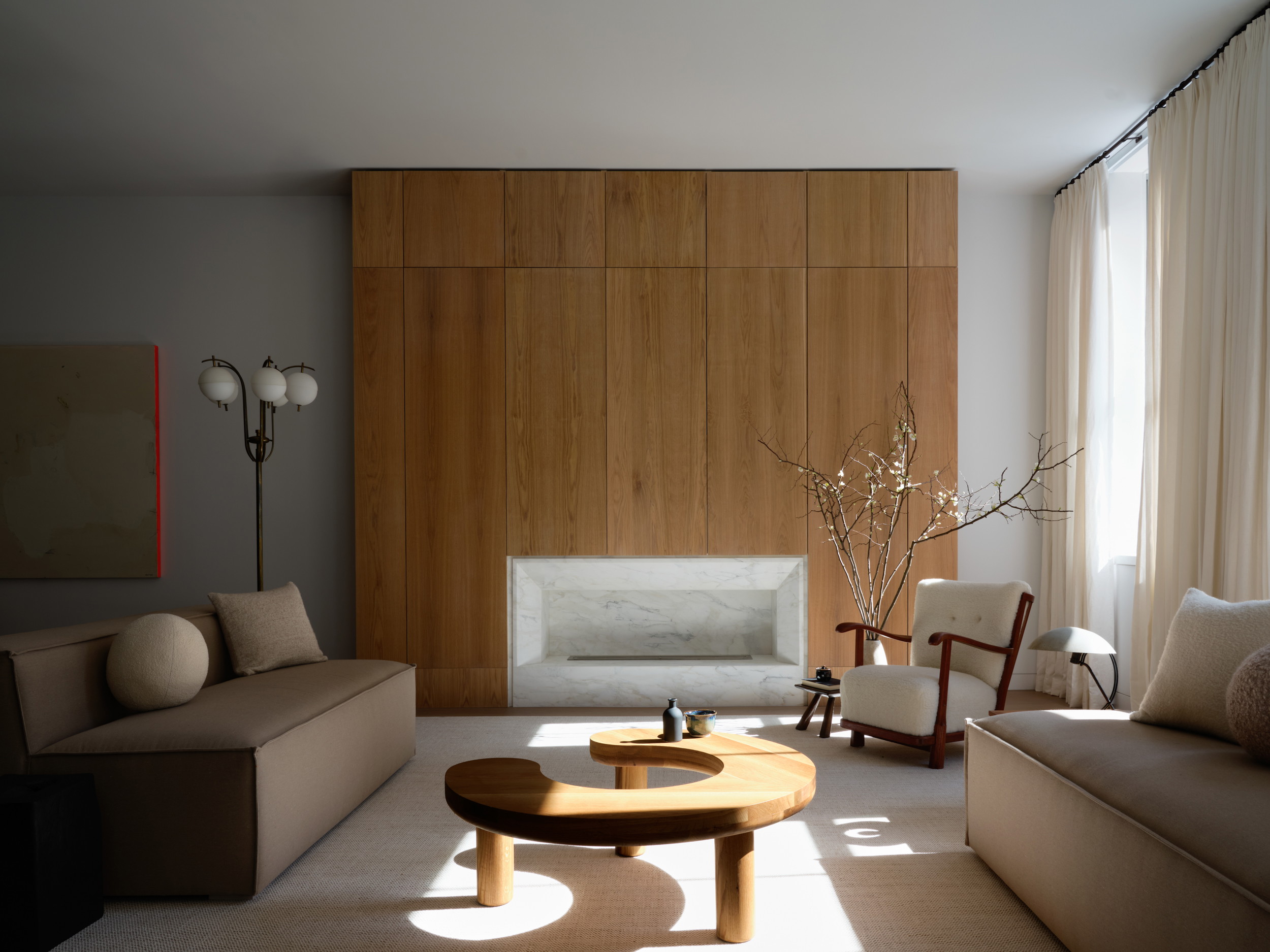 a living room filled with furniture and a wooden wall