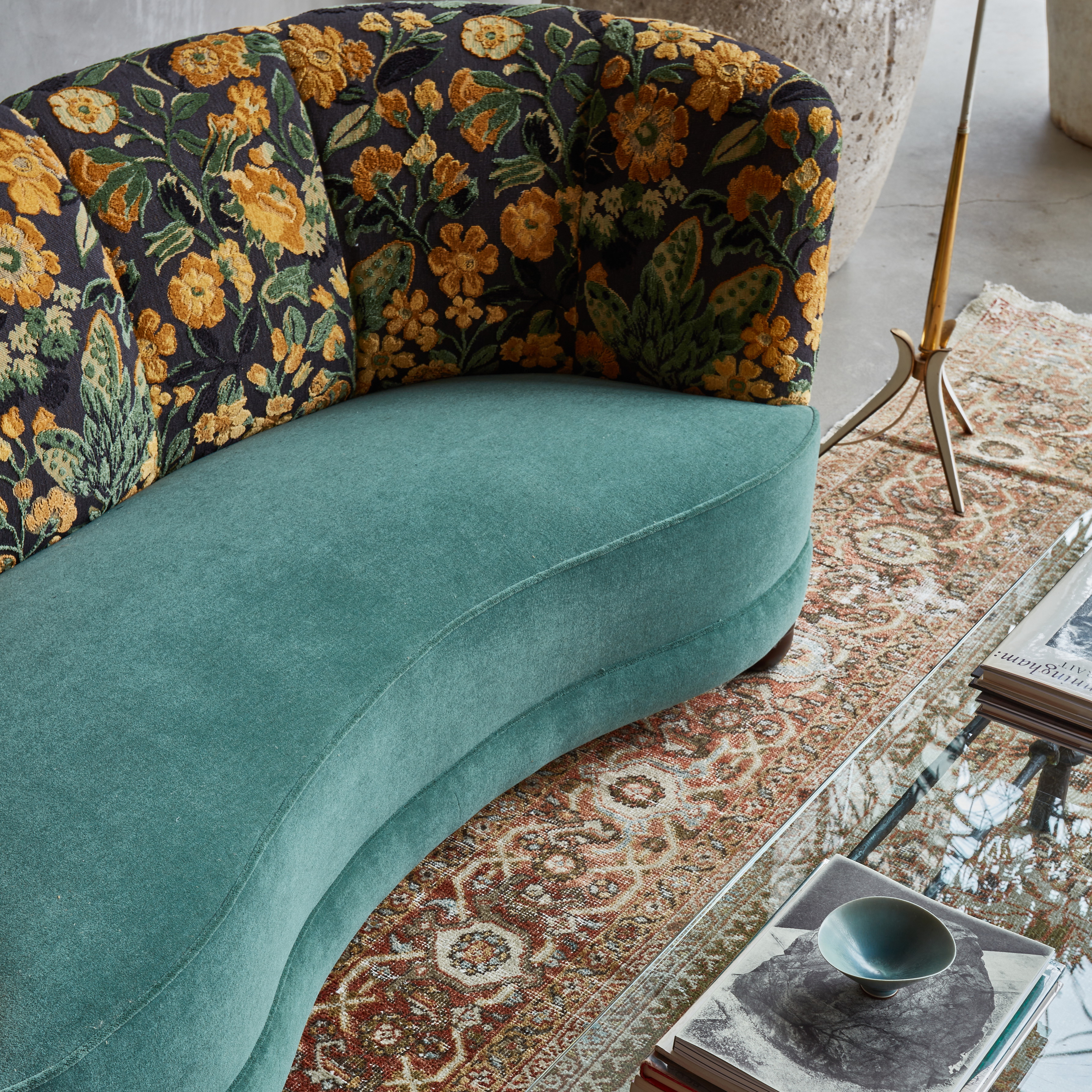 a blue couch sitting on top of a rug next to a table