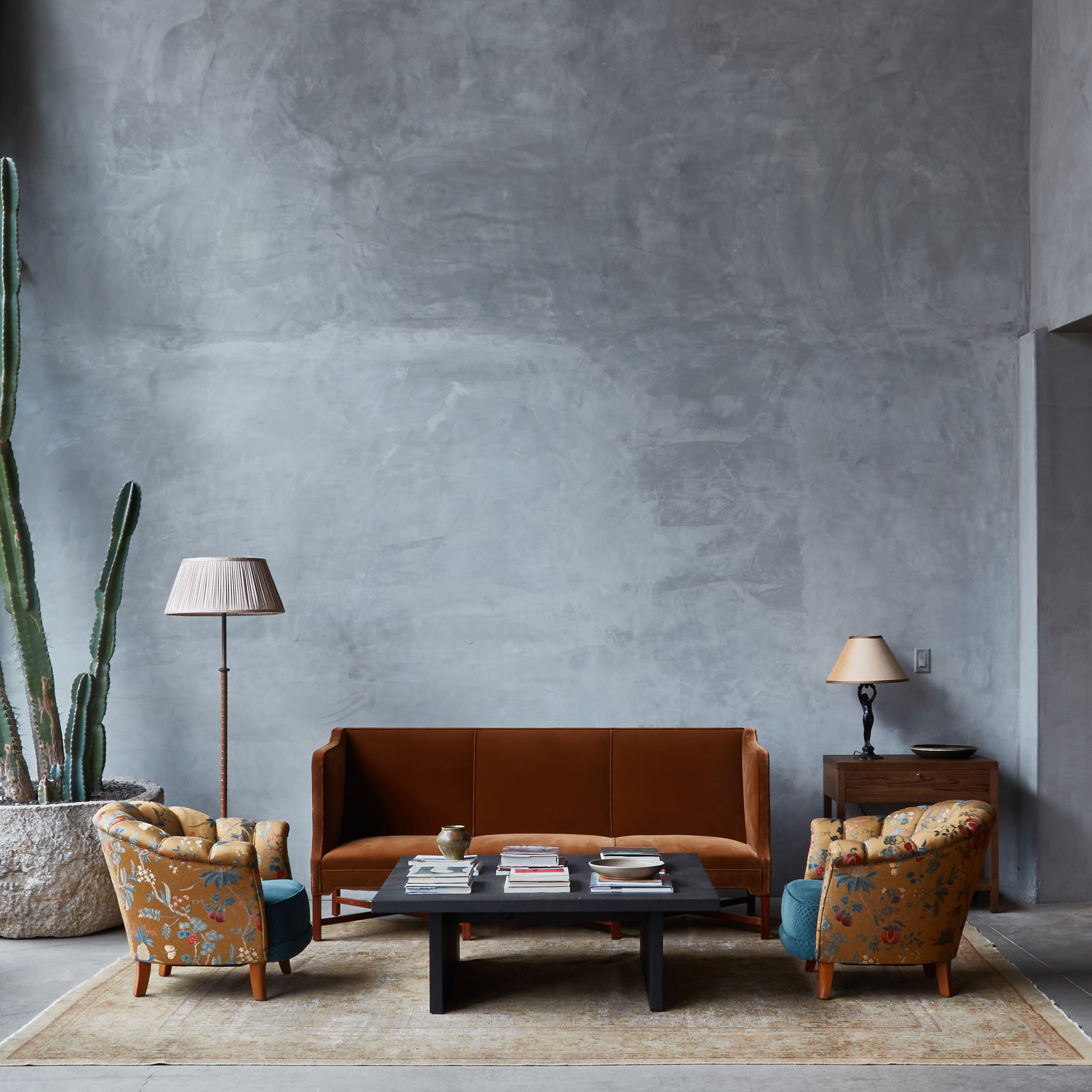 a living room filled with furniture and a cactus