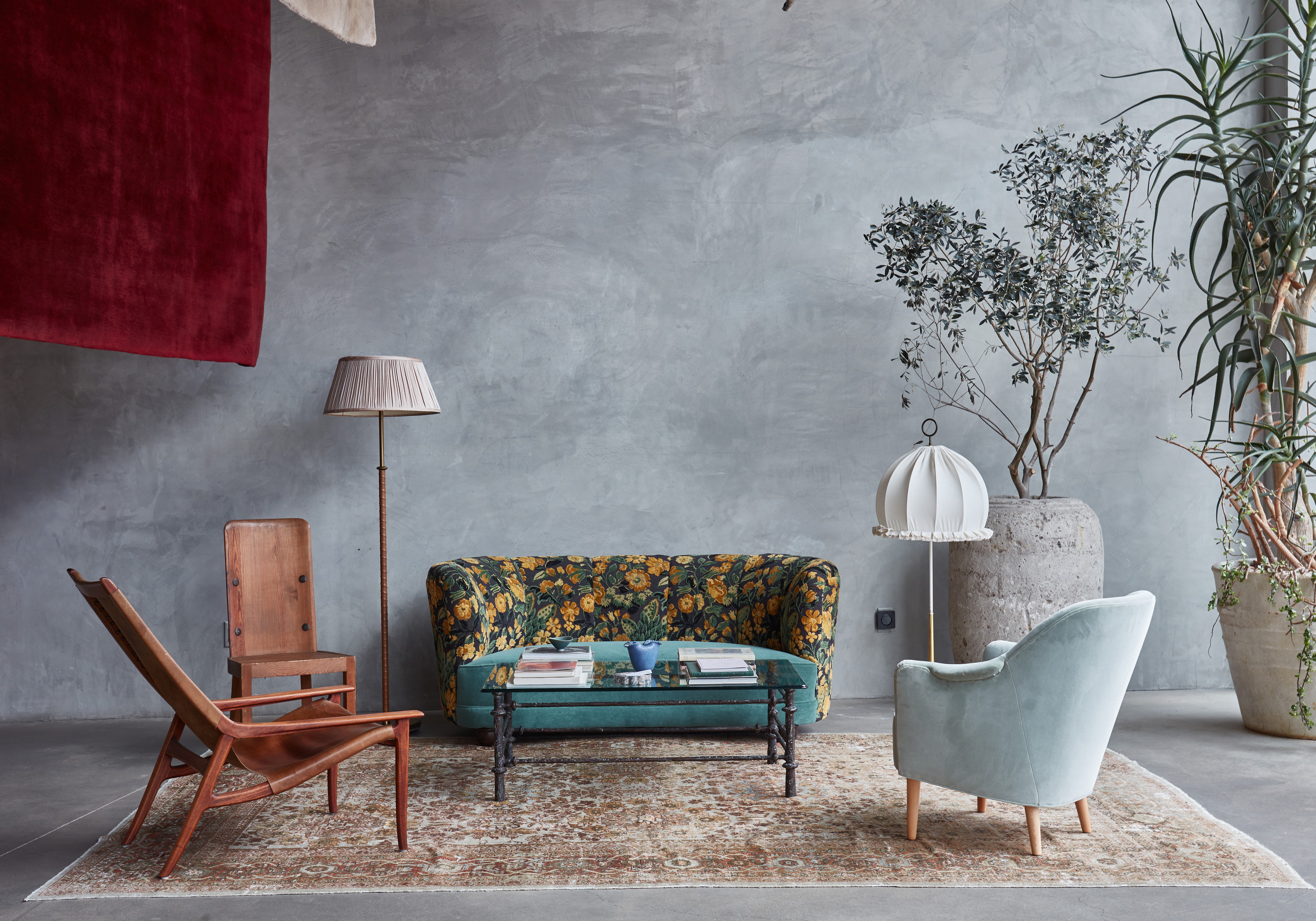 a living room filled with furniture and a plant