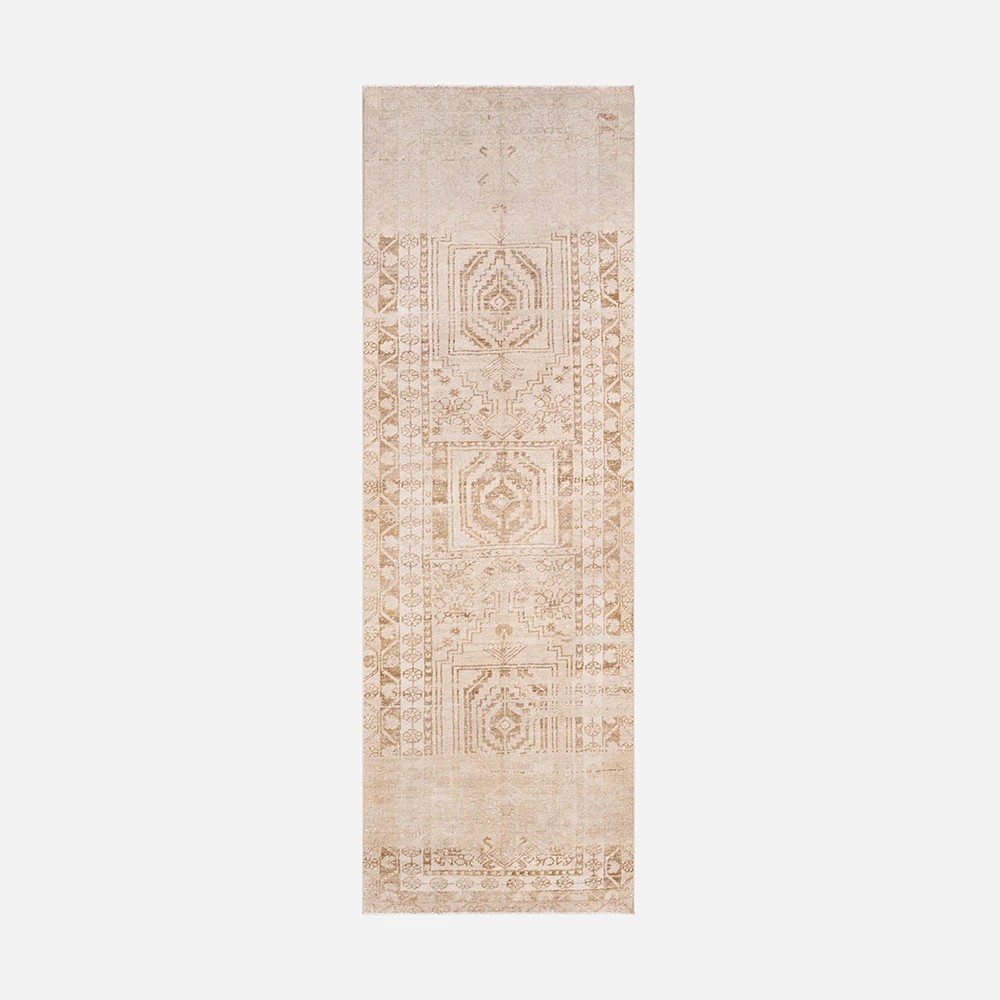 a beige rug with a design on it