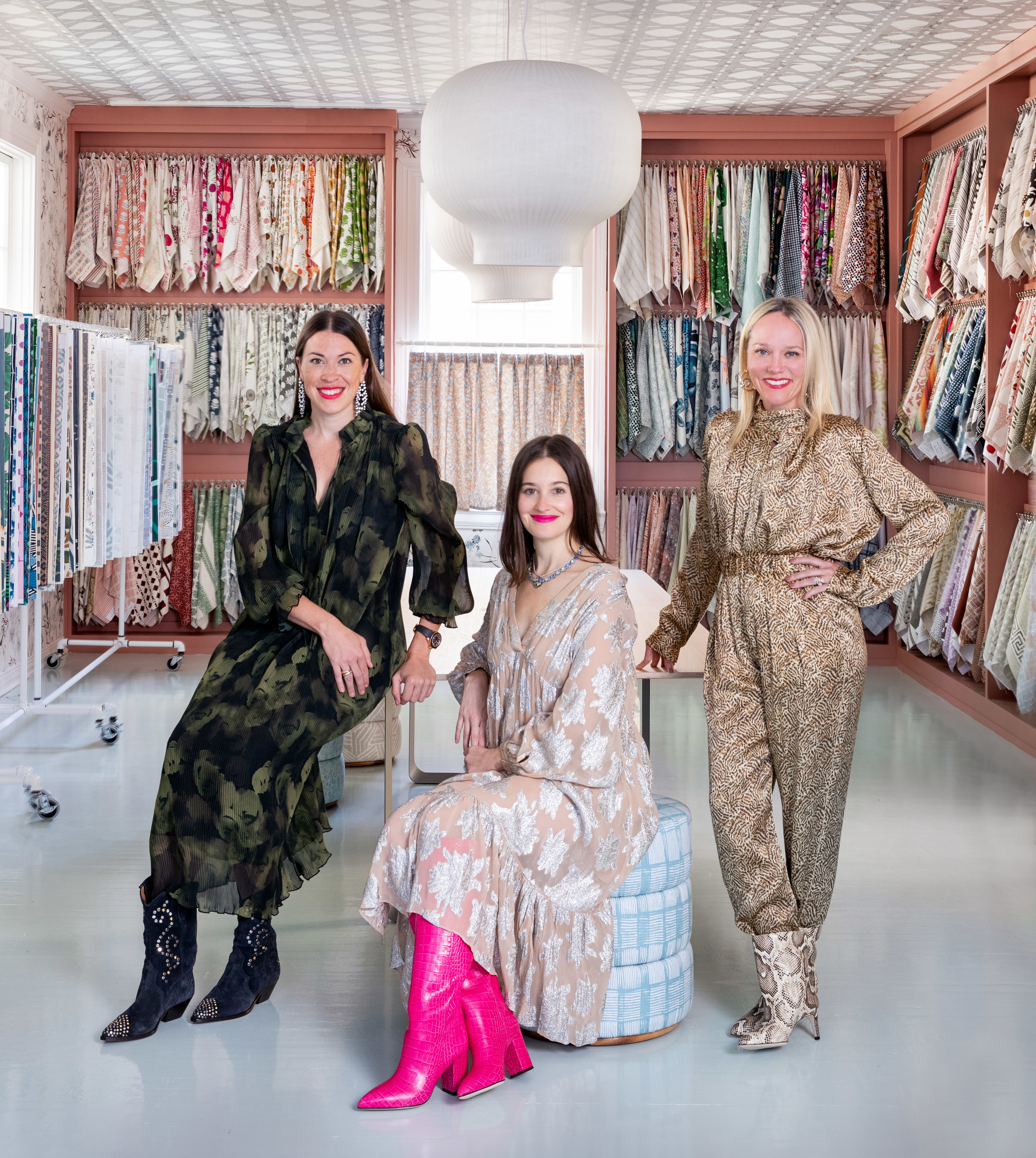 three women in a clothing store posing for a picture