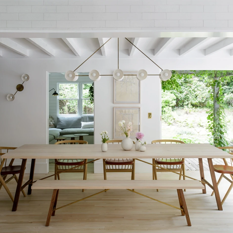 a dining room table with chairs and a bench