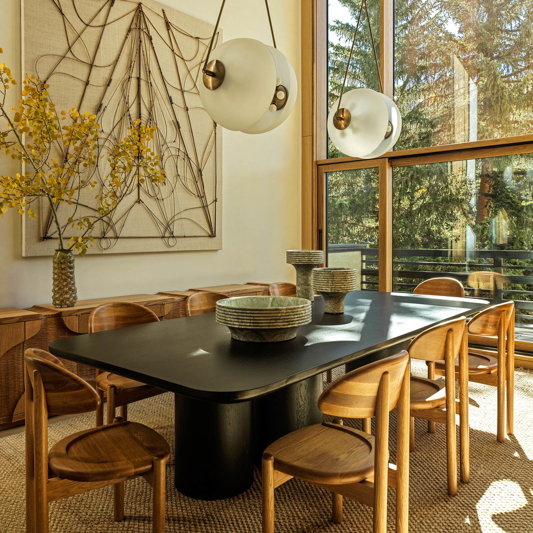 a dining room with a table and chairs
