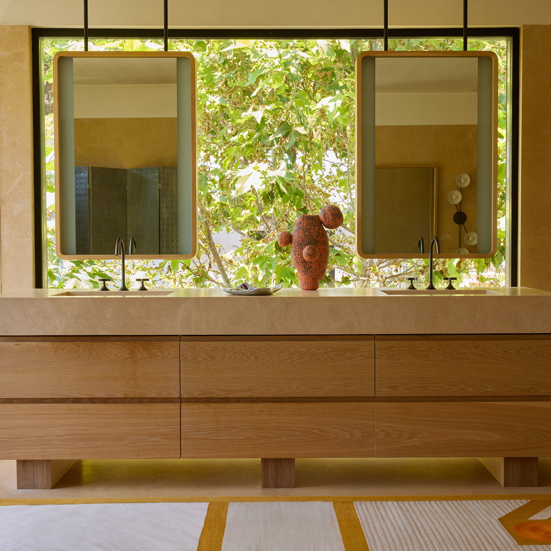 a bathroom with a large mirror and two sinks