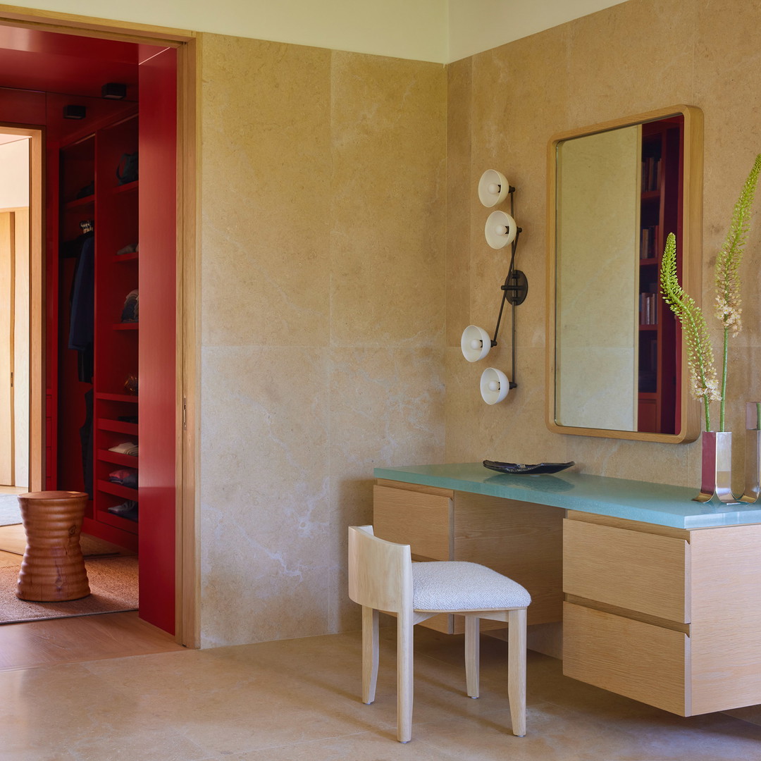 a bathroom with a vanity, mirror, and stool