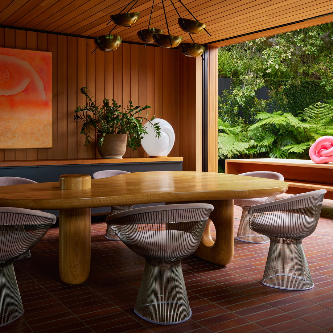 a dining room with a large wooden table and chairs