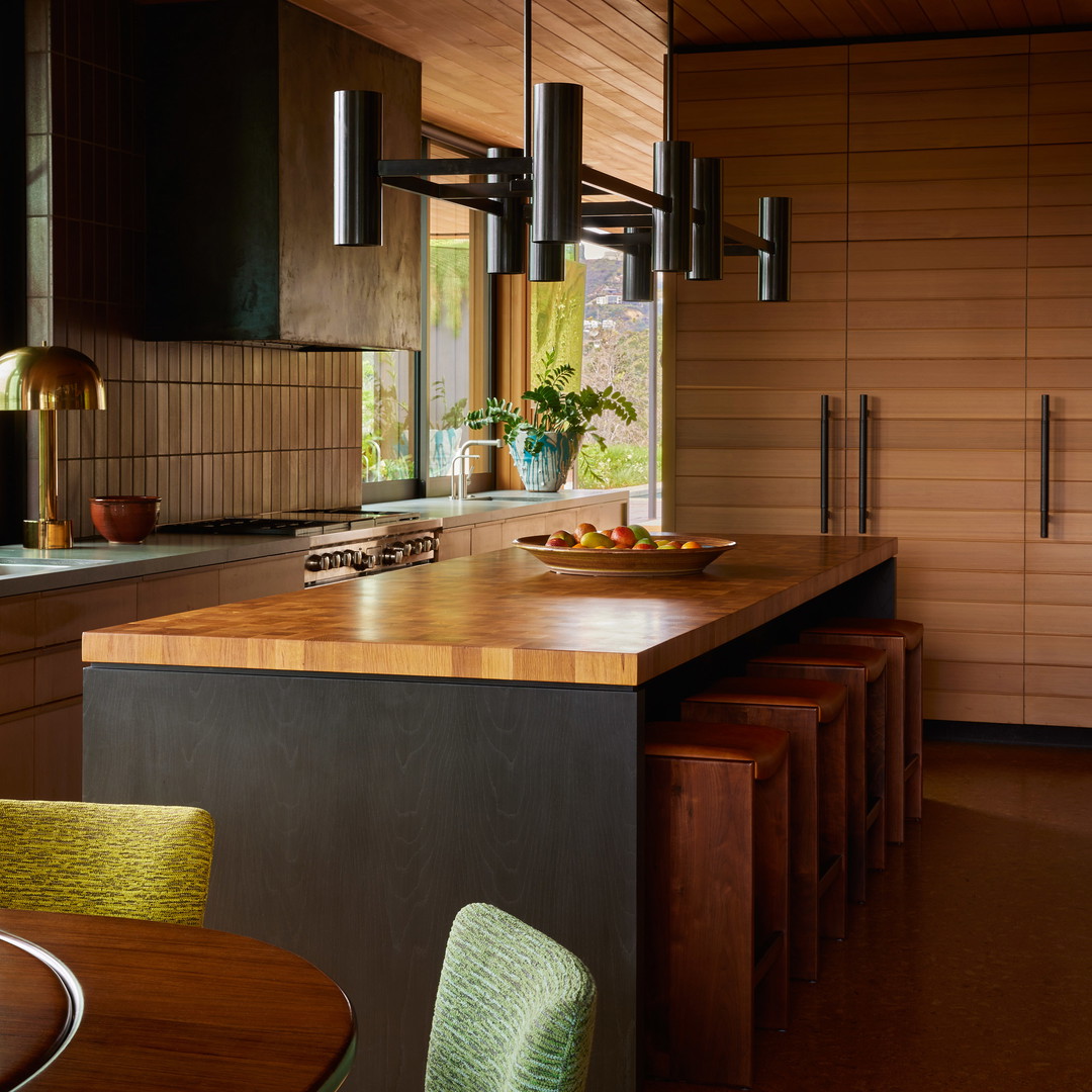 a kitchen with a center island with a wooden counter top