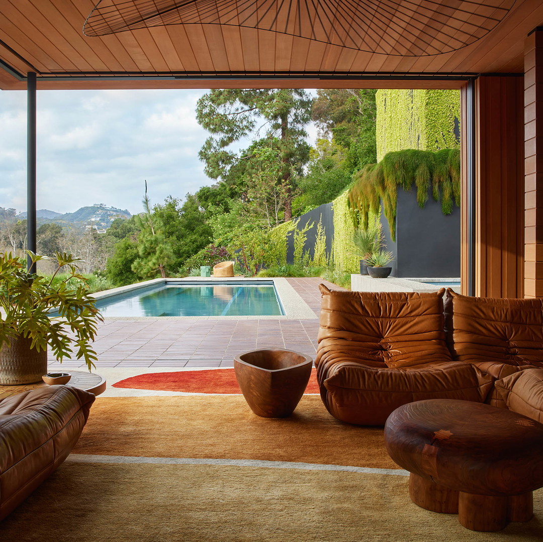 a living room filled with furniture and a large window