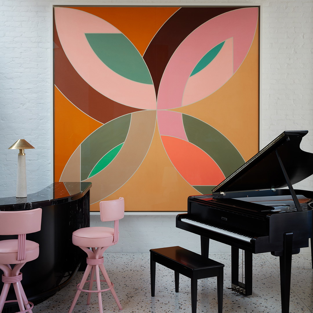 a room with a piano, stools and a painting on the wall