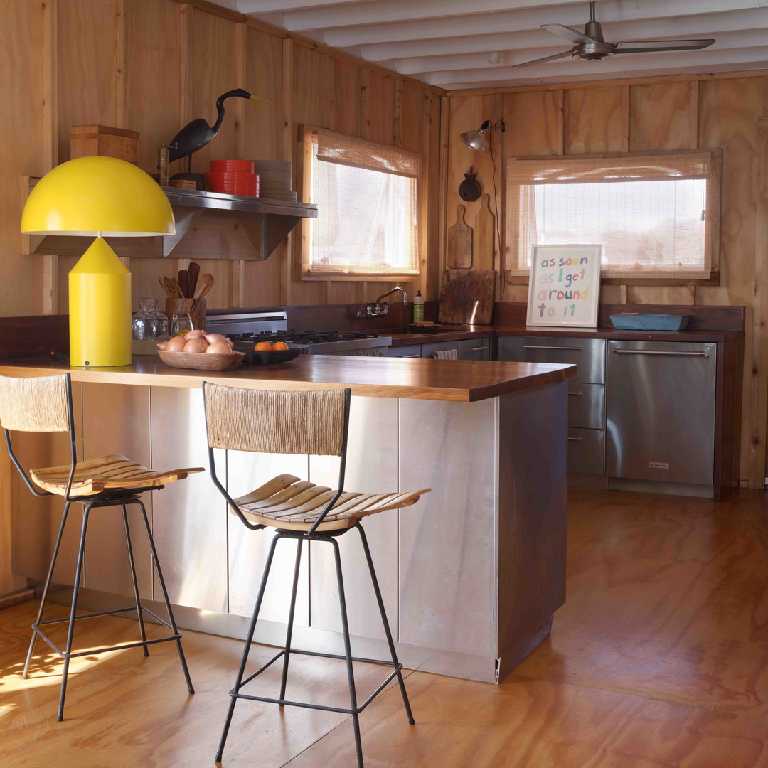 a kitchen with a table and two chairs in it