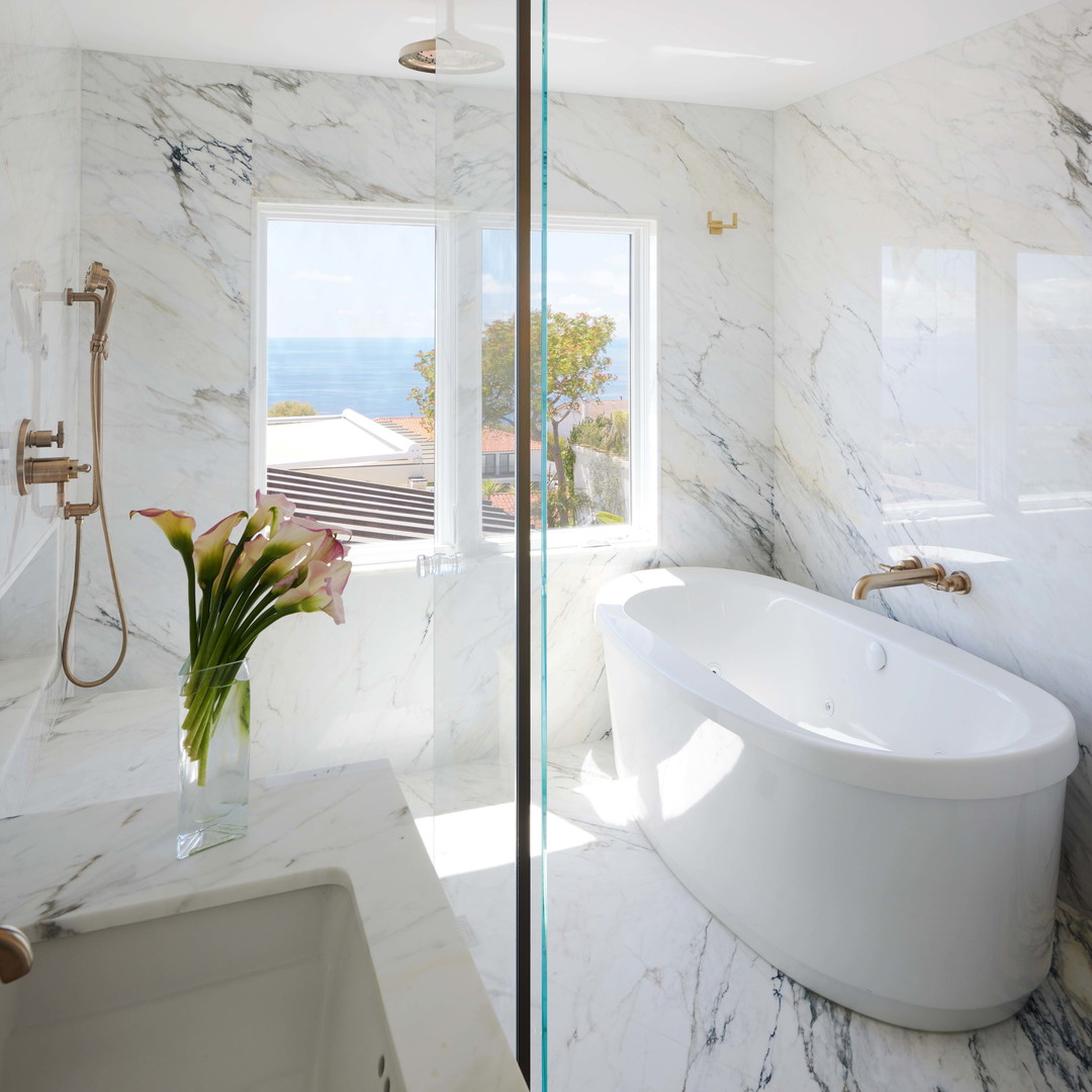 a bathroom with a bathtub, sink, and window