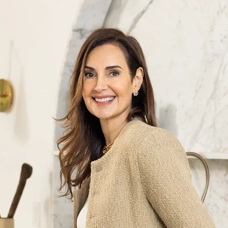 a woman leaning on a counter in a kitchen