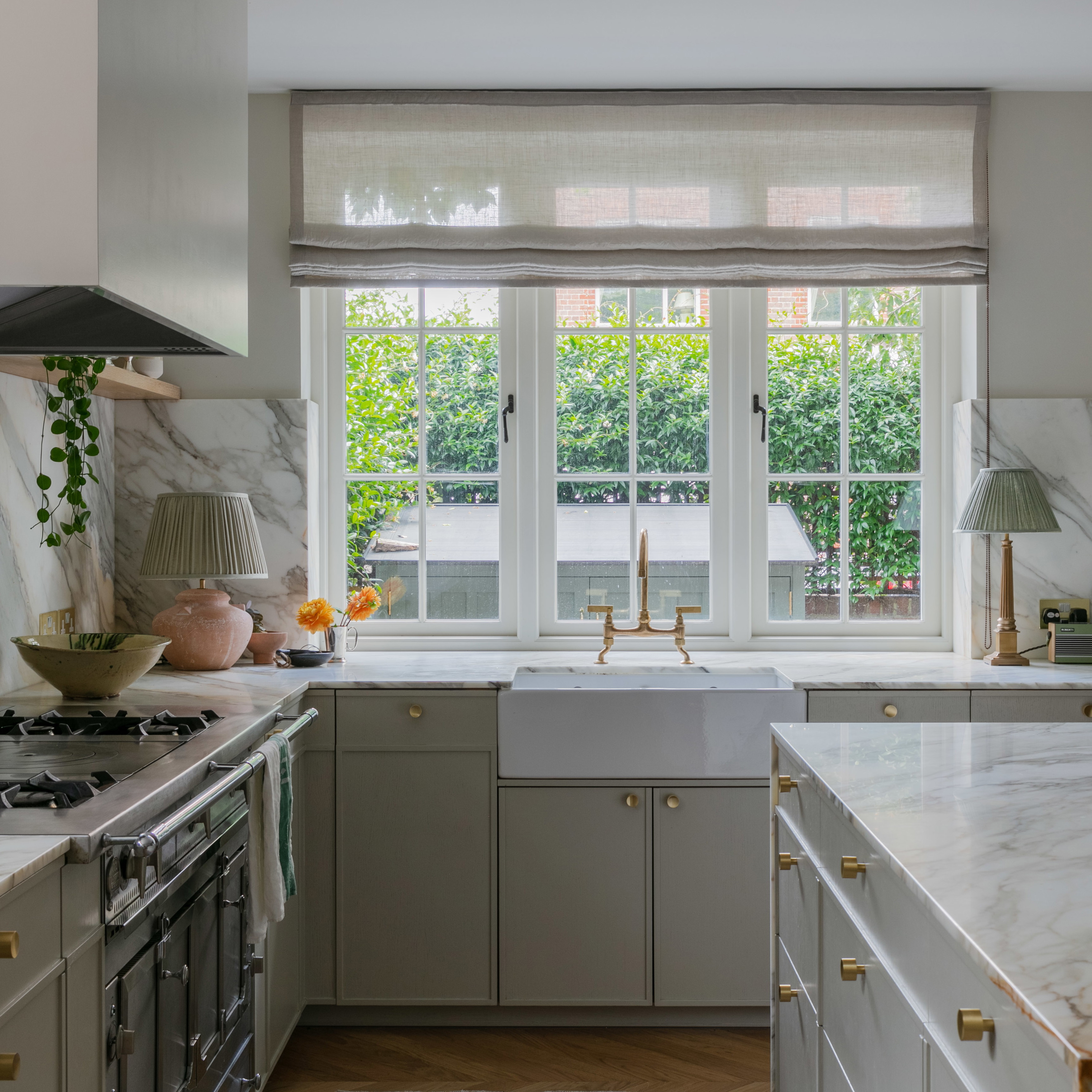 a kitchen with marble counter tops and a large window