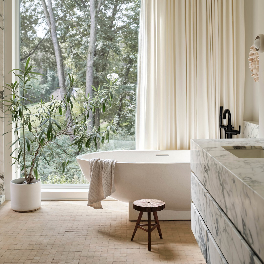 a bathroom with a tub and a large window