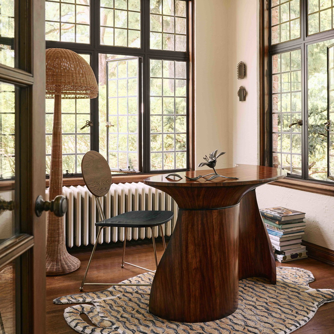 a room with a table, chair, radiator and a radiator