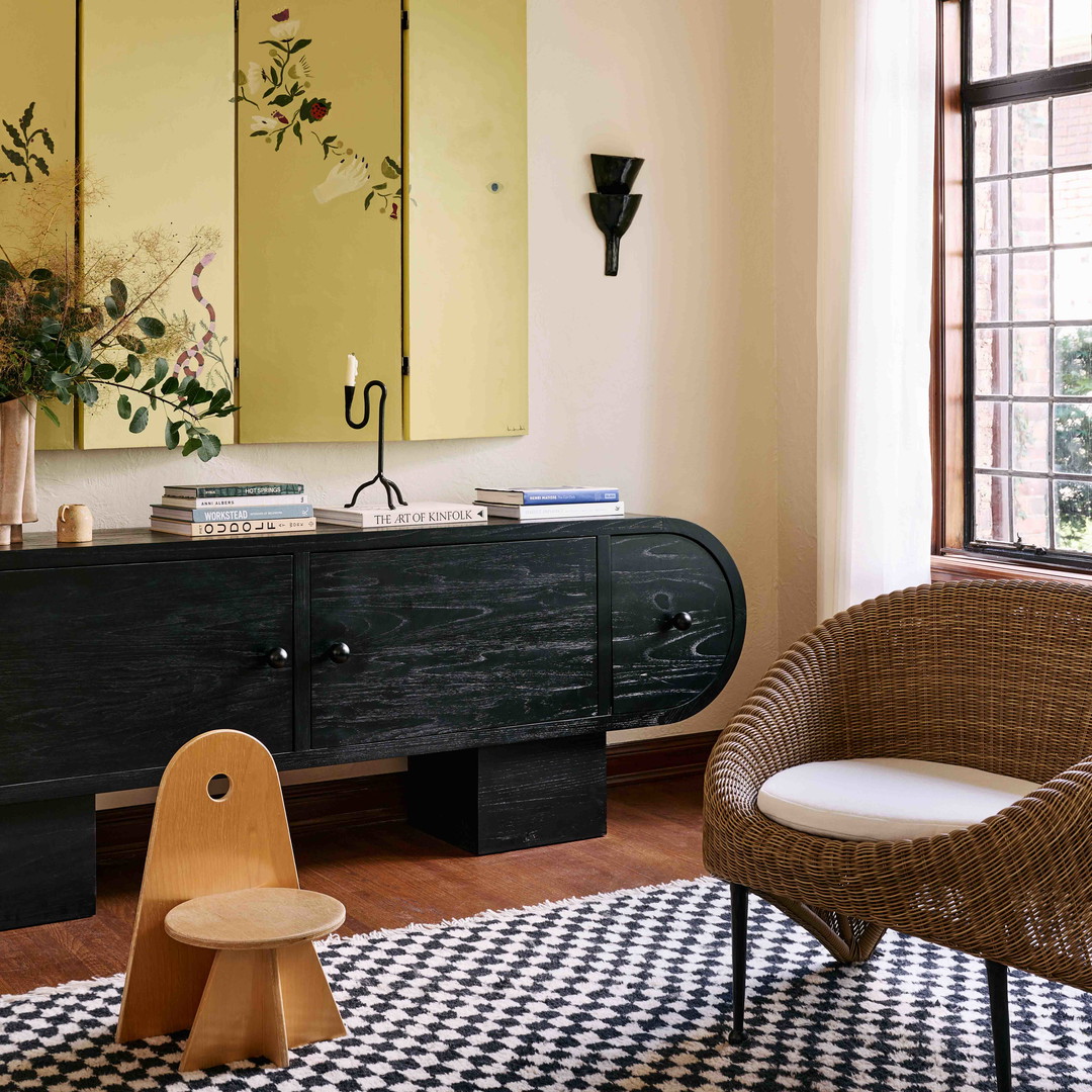 a living room with a black and white checkered rug