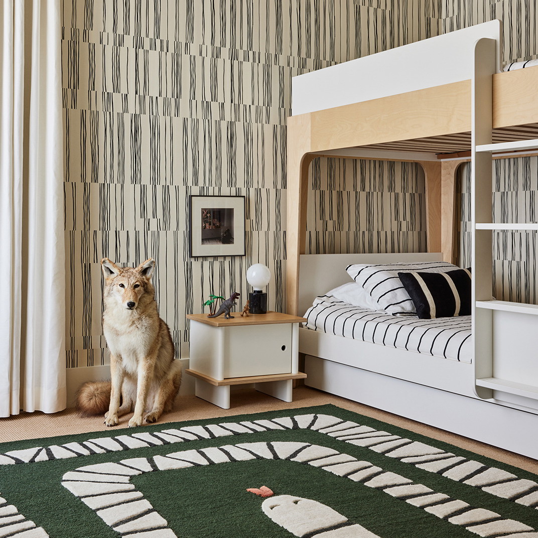 a dog sitting on the floor of a bedroom