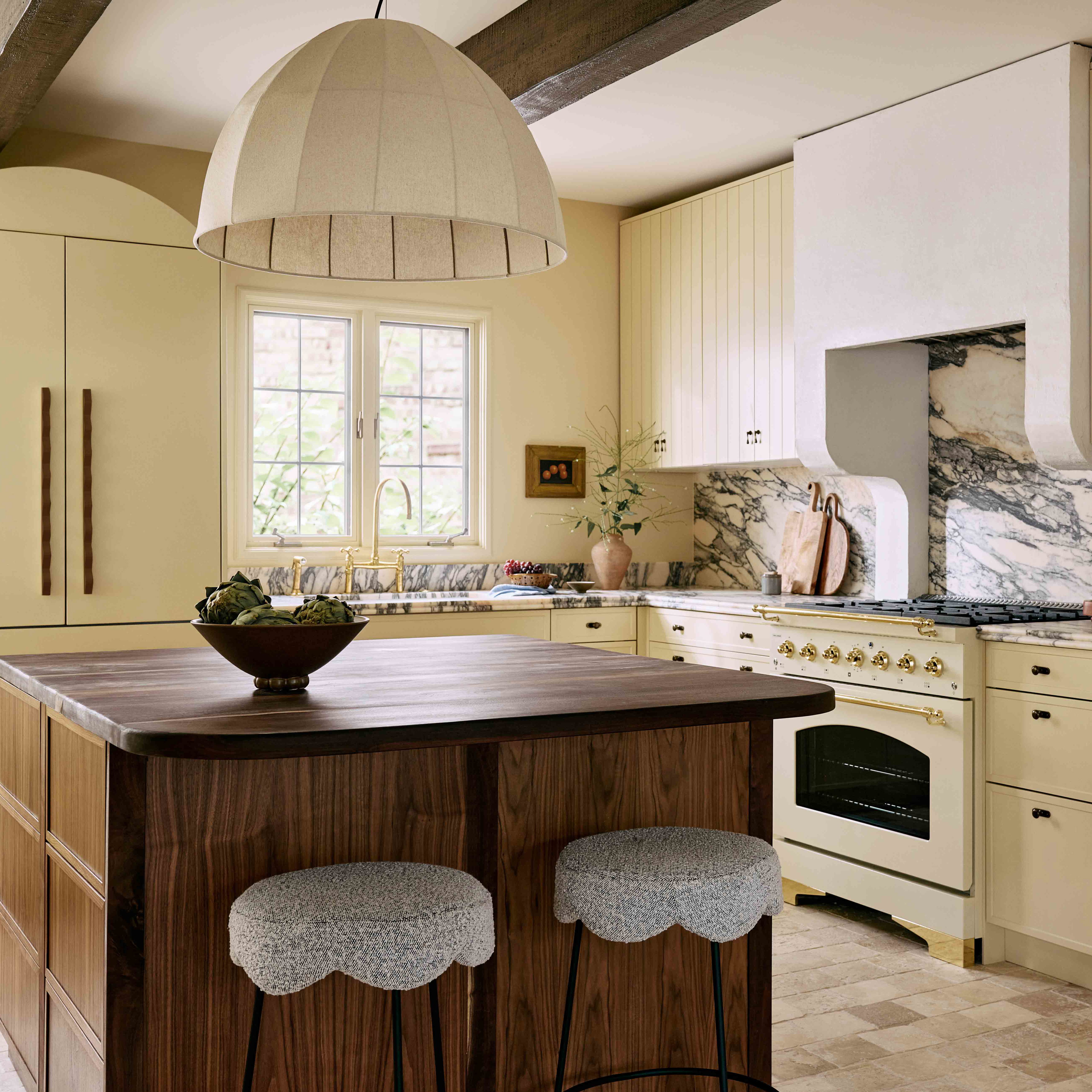 a kitchen with a center island with stools