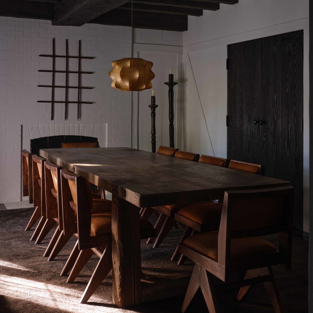 a large wooden table surrounded by wooden chairs