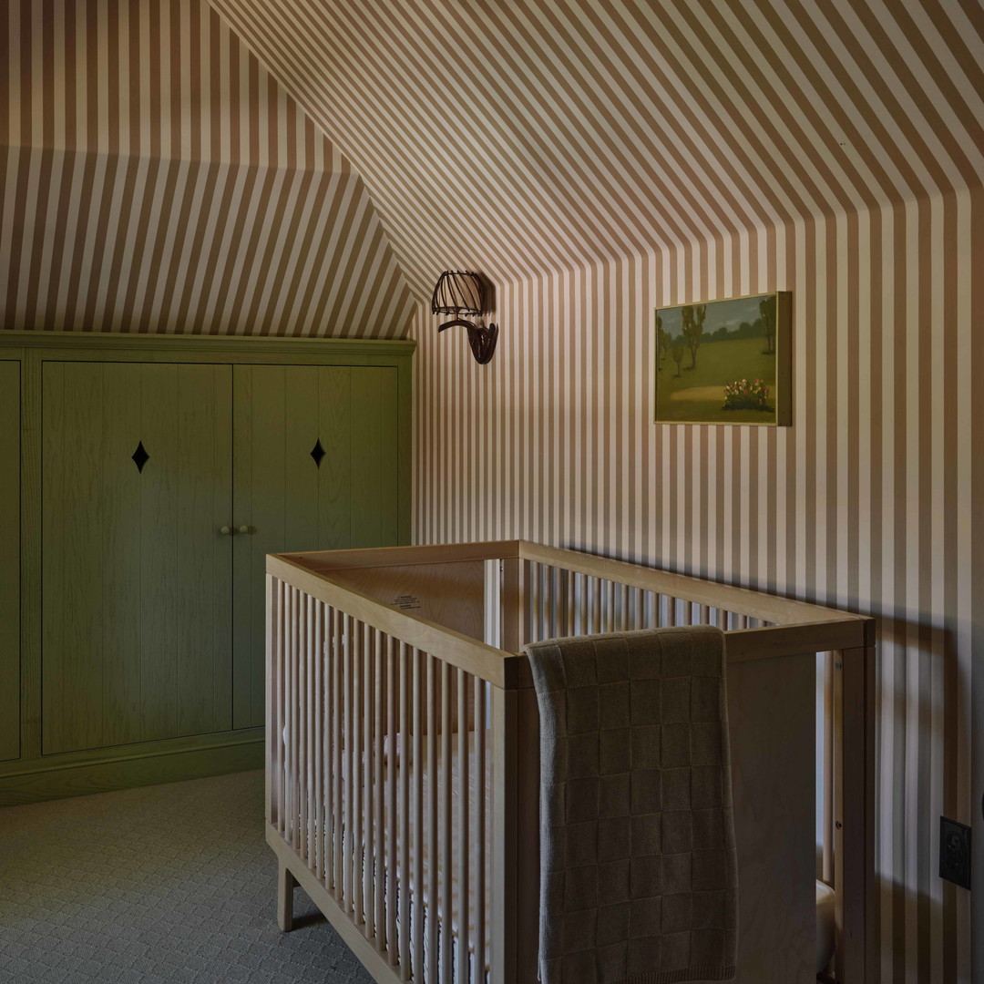 a baby crib in a room with striped walls