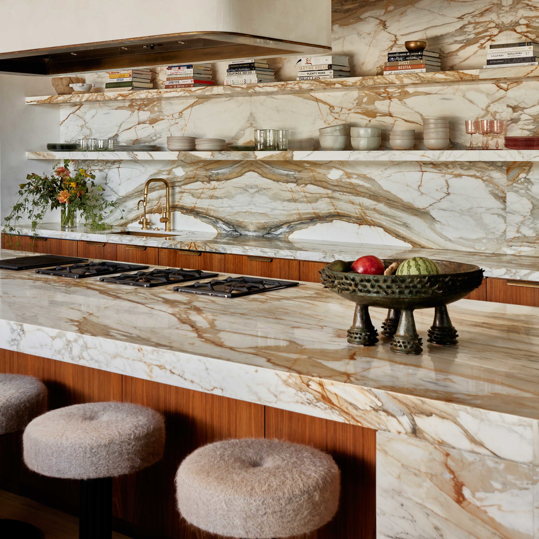 a bowl of fruit on a counter in a kitchen