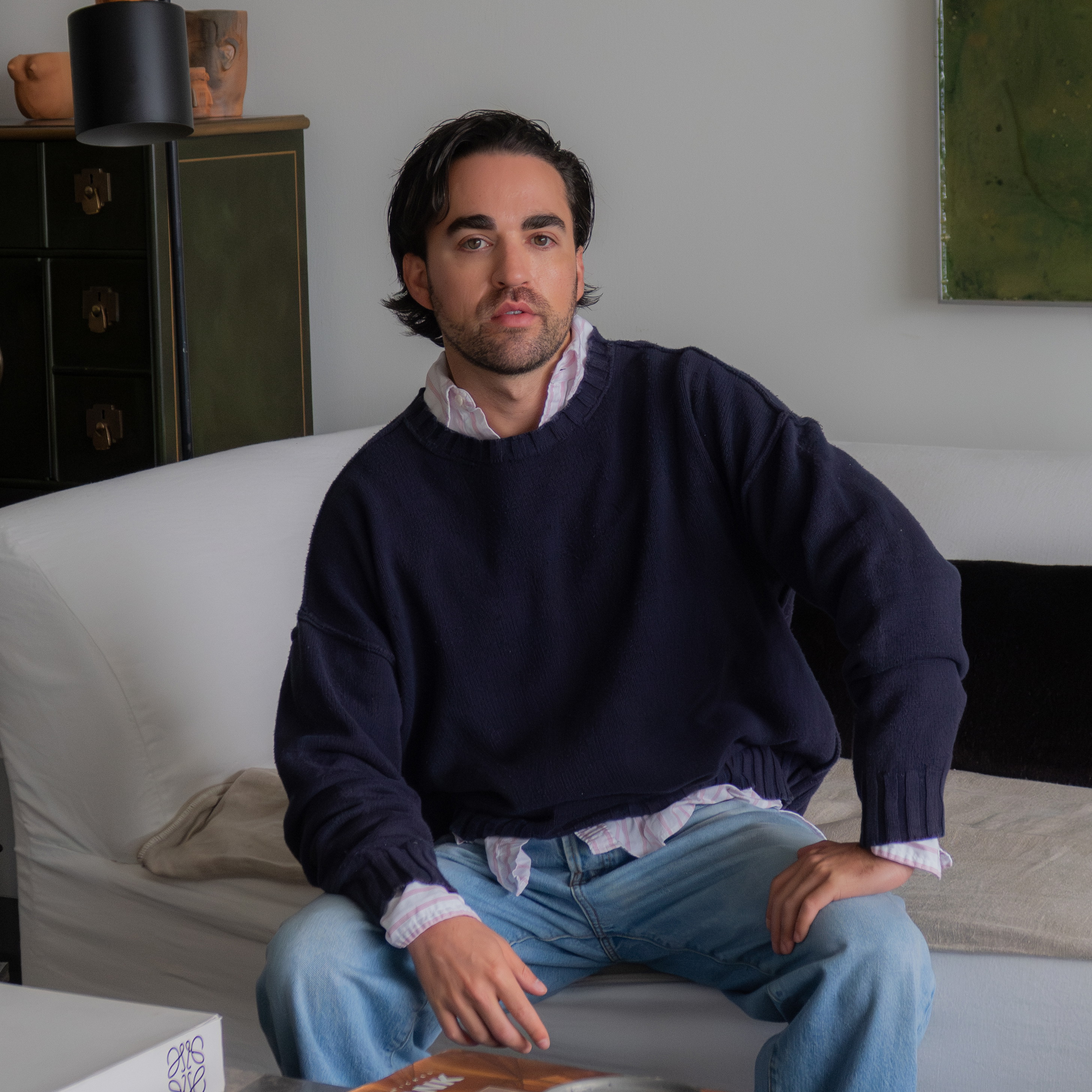 a man sitting on a couch in a living room