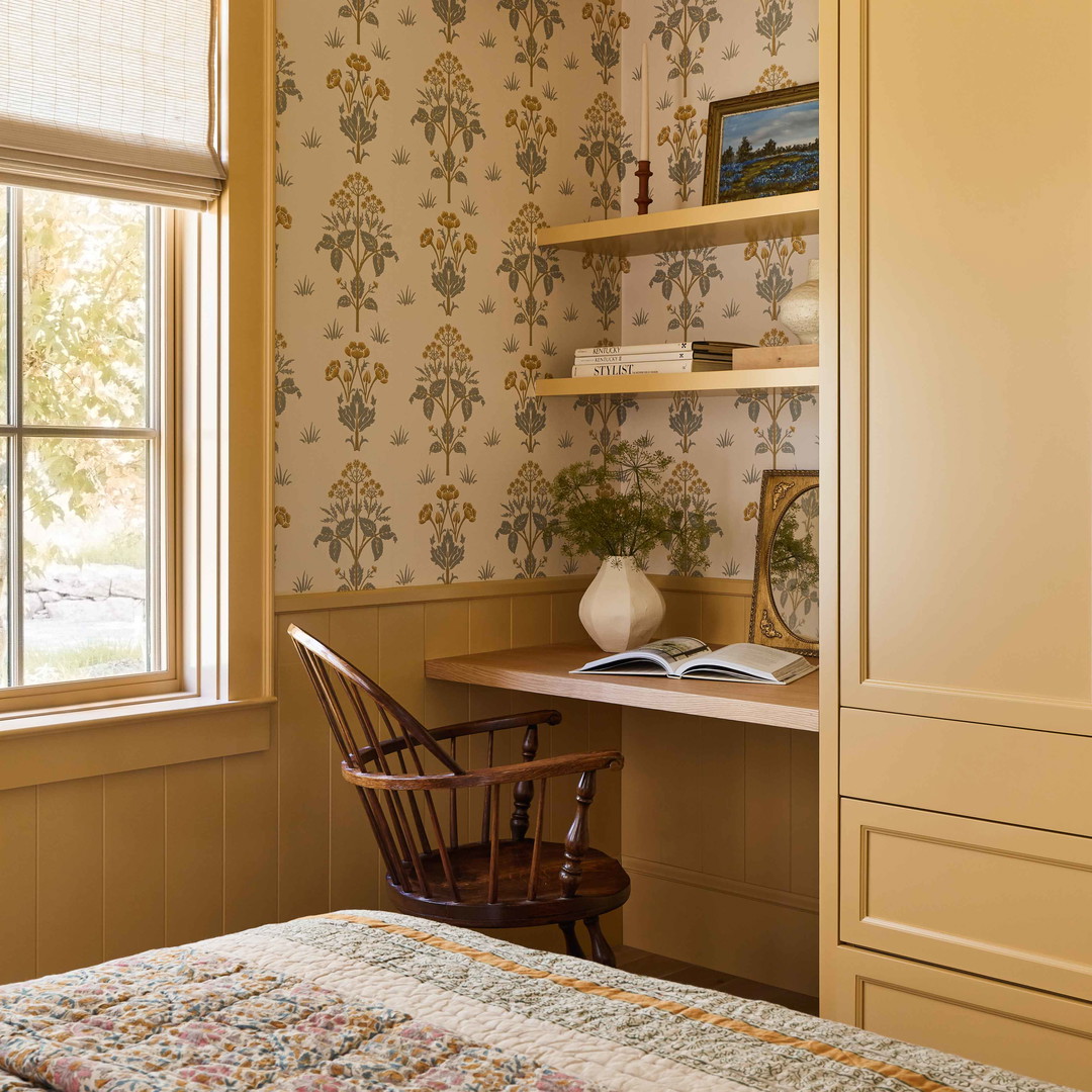 a bedroom with a bed, desk and window