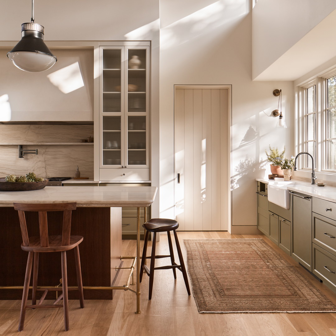 a kitchen with a table and stools in it