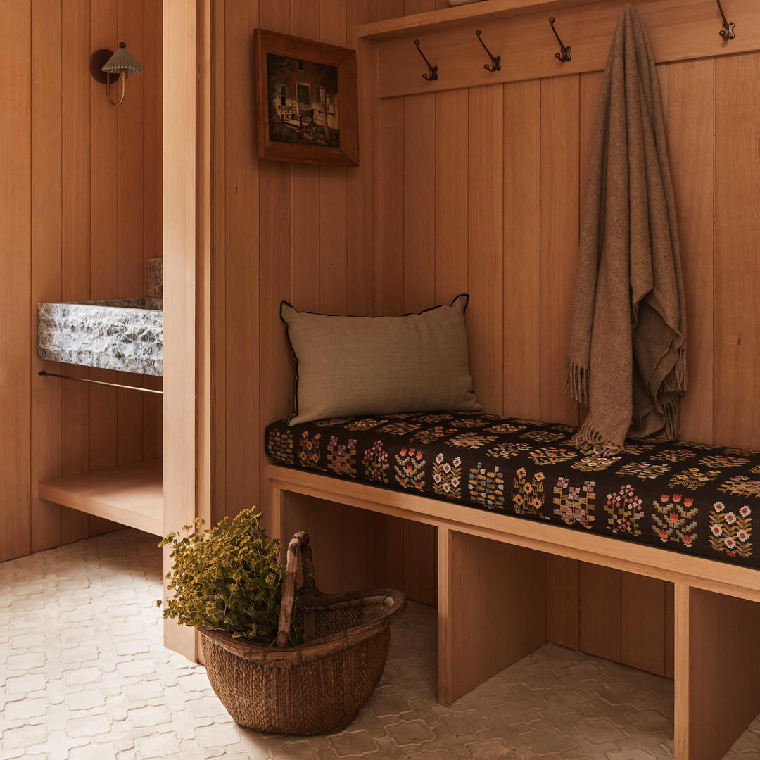 a wooden bench with a blanket on top of it