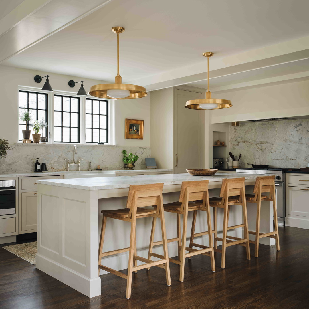 a kitchen with a center island and three stools