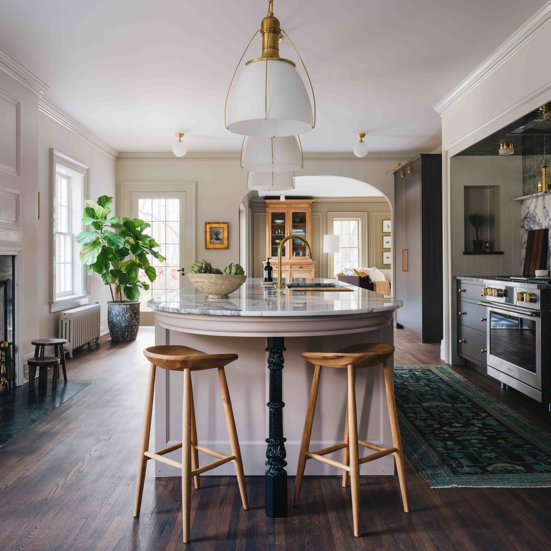 a kitchen with a center island and two stools