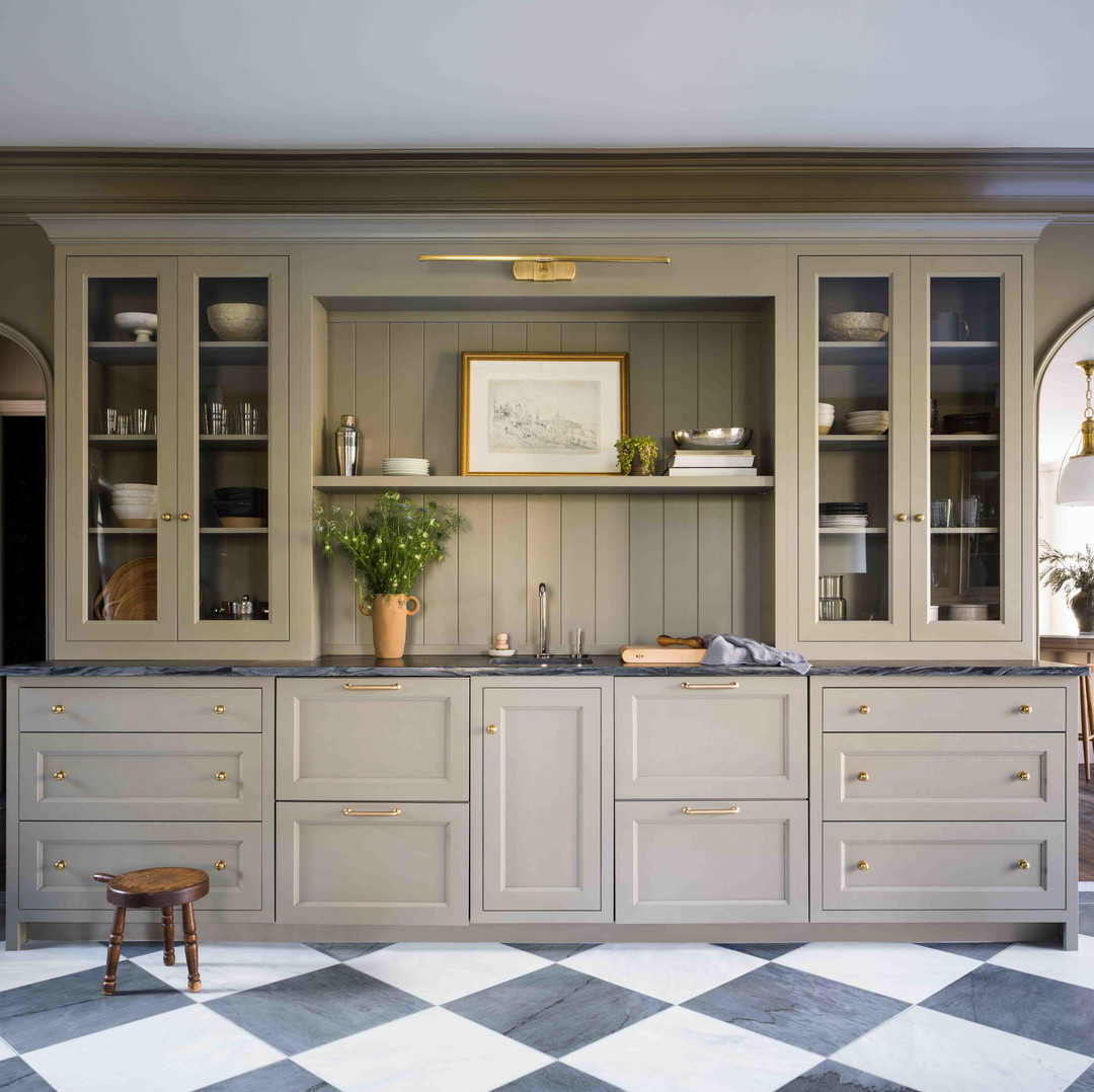 a kitchen with a checkered floor and cabinets